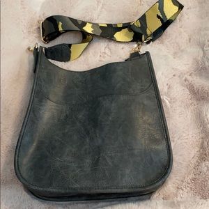 Gray leather cross body with camouflage strap